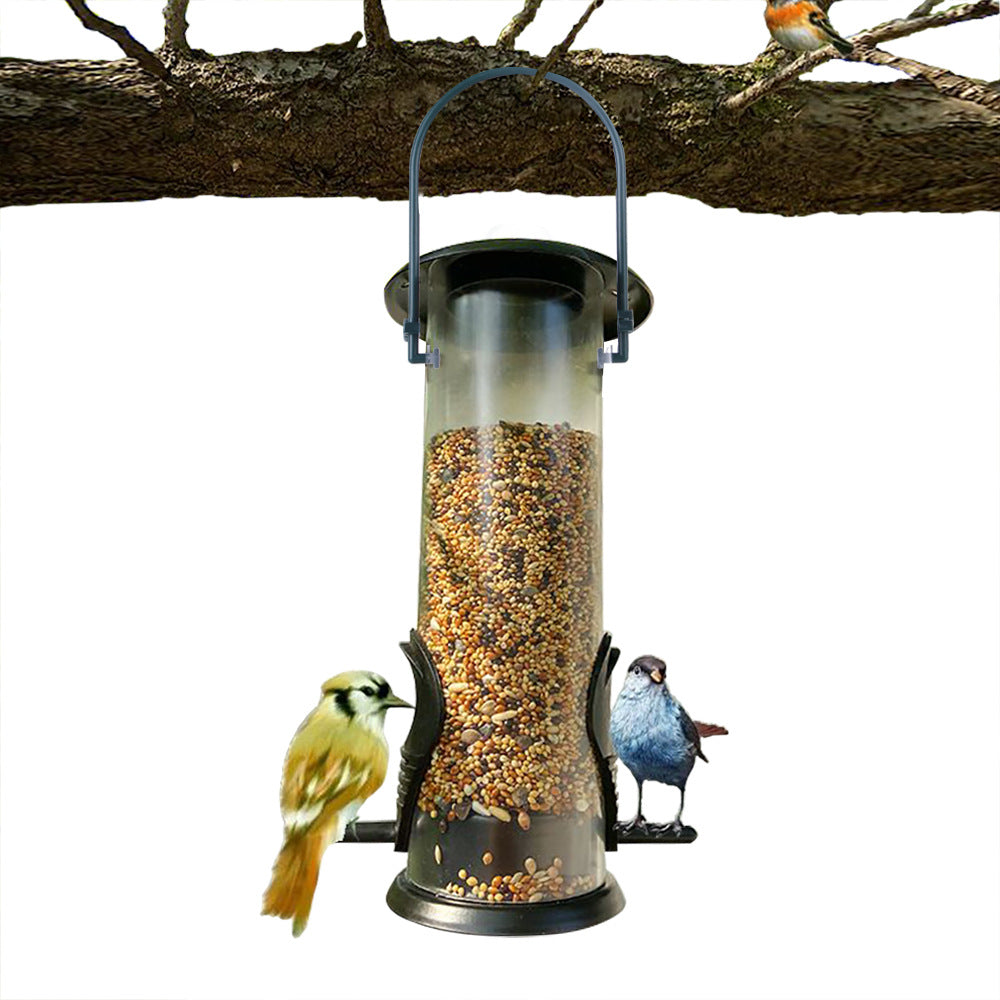 Tube feeder hanging from a branch with birds