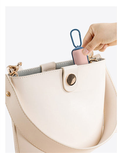 Dispenser clipped to a handbag