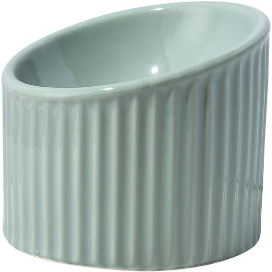 Cat eating from an elevated ceramic bowl